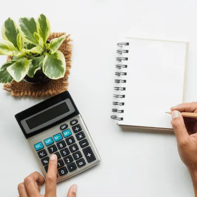 a photo of a calculator and a notebook